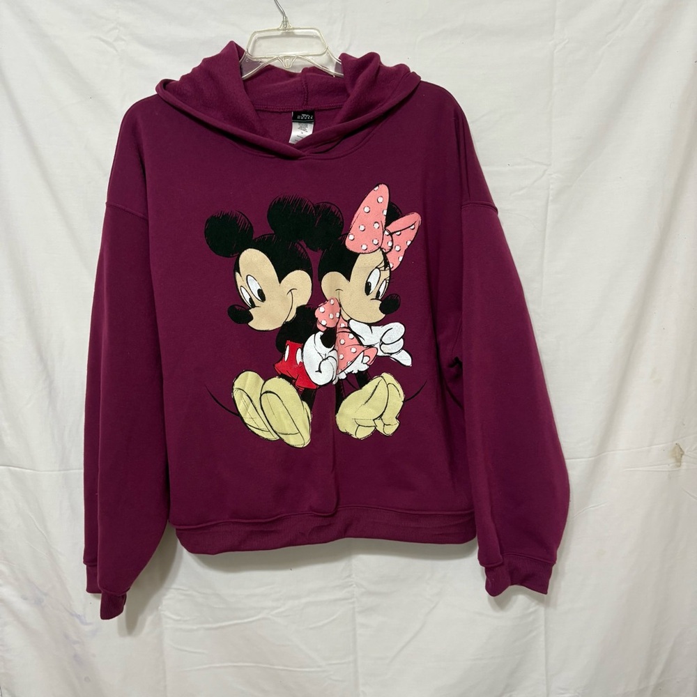 Disney purple hoodie featuring a graphic of Mickey and Minnie Mouse.